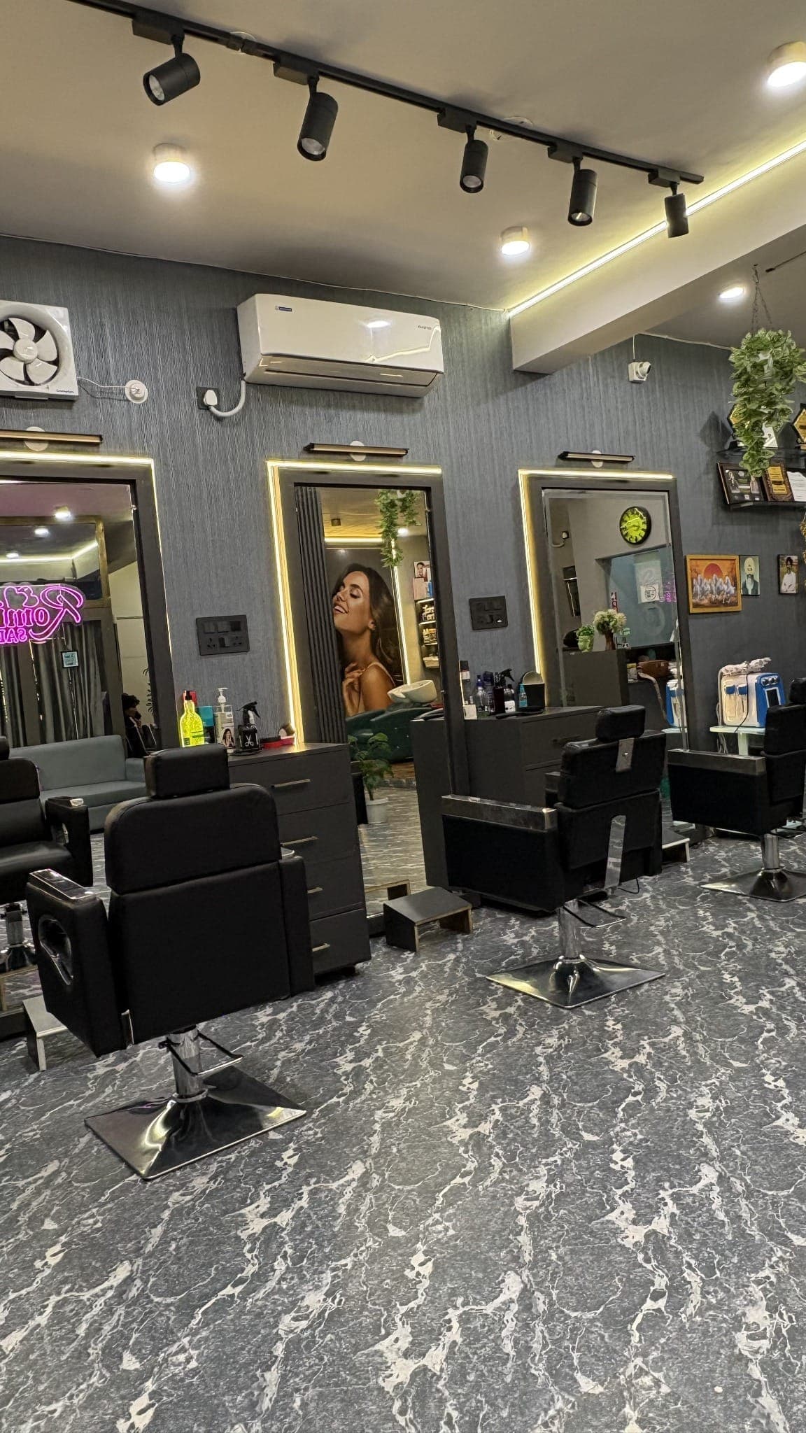 Styling chairs and mirrors inside Romi's Family Salon, Krishna Nagar, Satna